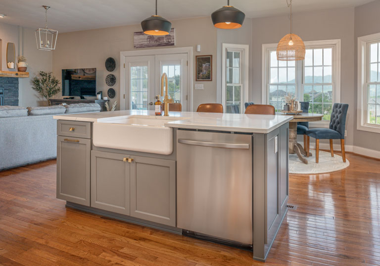 kitchen island cabinetry with farmhouse style sink and stainless dishwasher