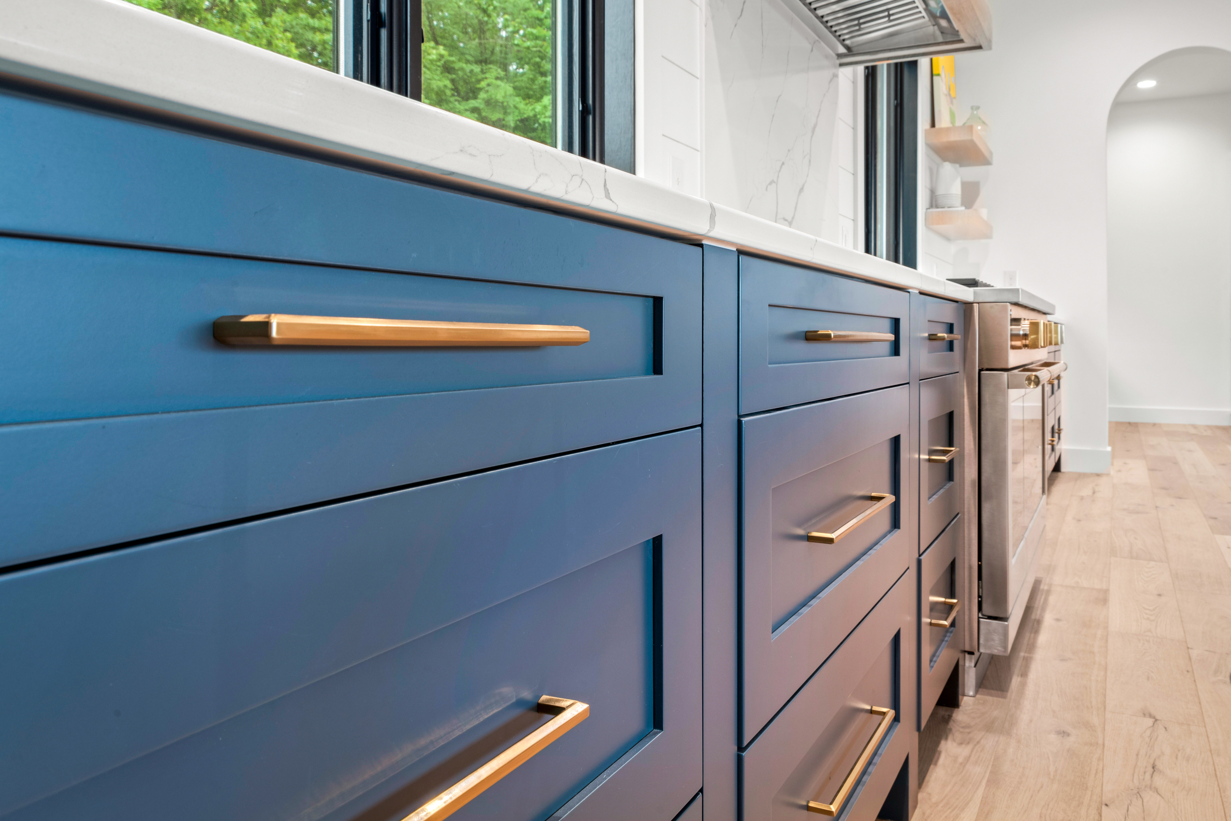kitchen island cabinetry with farmhouse style sink and stainless dishwasher
