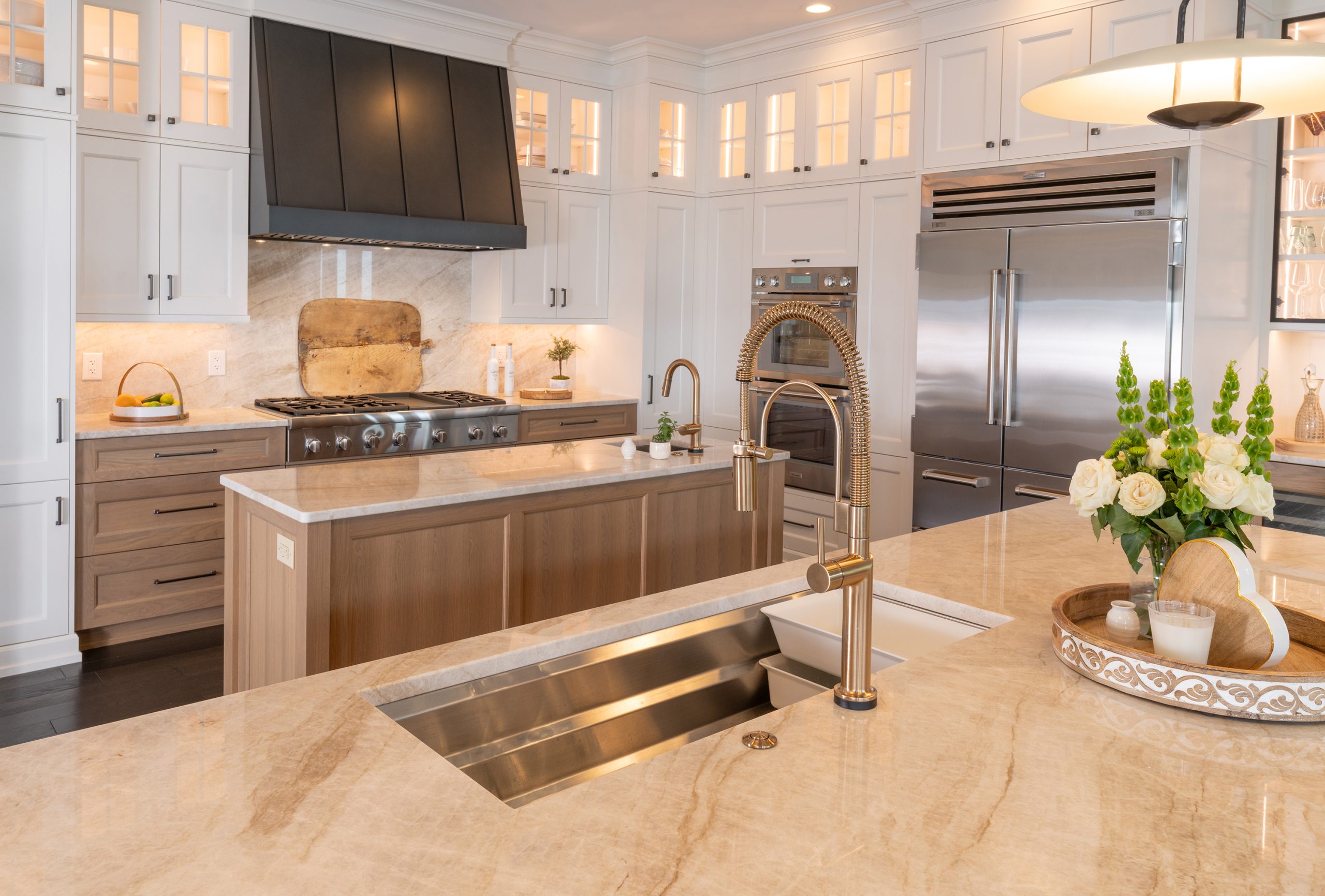 kitchen cabinet design studio in roanoke virginia features white cabinets with blue tile backsplash and white marble countertops and range hood