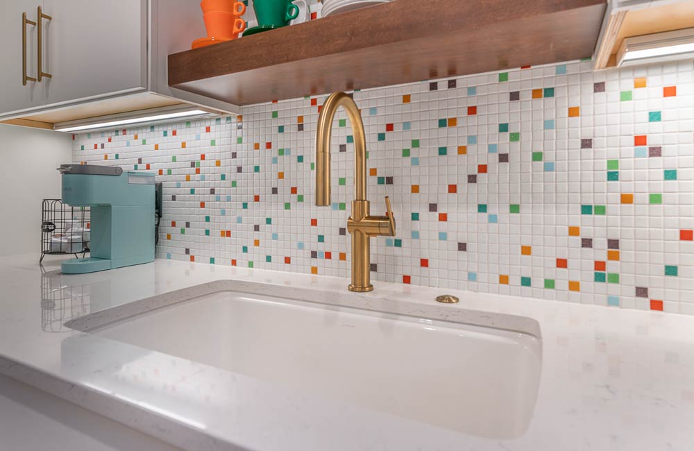 ideal cabinets becky ross kitchen design gold faucet multi-color backsplash