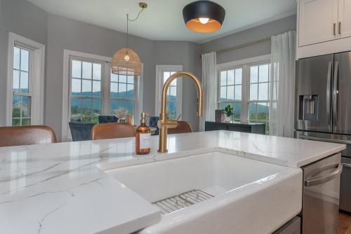 becky ross kitchen desigh featuring white countertop with gold faucet fixture