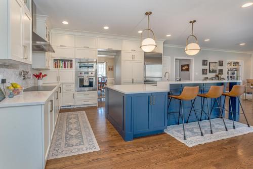 greg papenfus stewart kitchen design featuring blue base cabinet kitchen island and bar stools