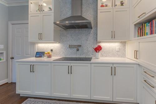 greg papenfus stewart kitchen design with white cabinetry and stainless steel range hood
