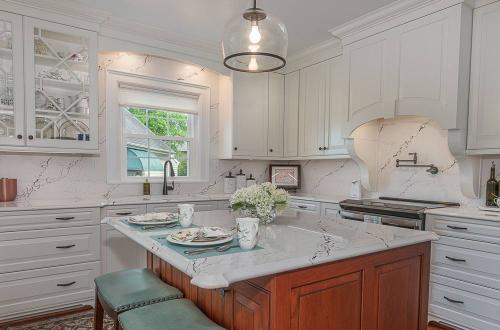 ideal cabinets becky ross kitchen design sea green with white cabinets, white countertop and wood cabinet island