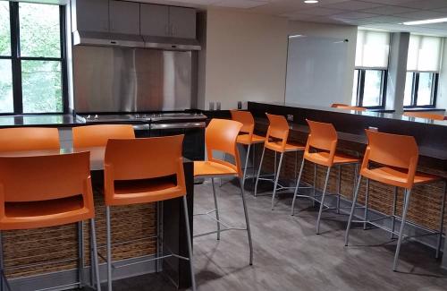 ideal cabinets dean saltus commercial design orange bar stools and black cabinetry and countertops